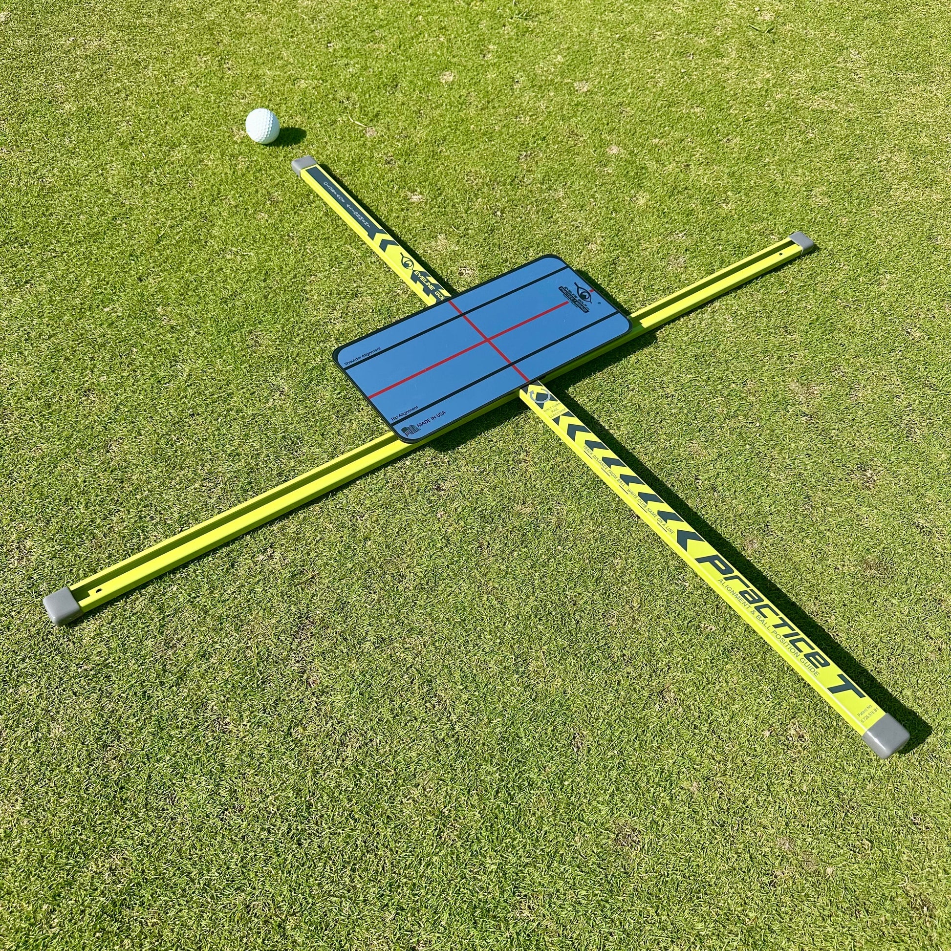 Golf practice device on a grassy surface with a golf ball nearby